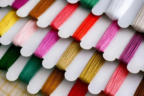 Colored embroidery threads on spools. Stock Photos