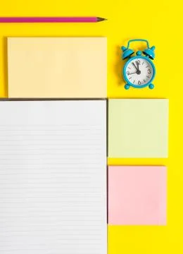 Colored empty papers with copy space on the yellow background table. Flat lay Stock Photos