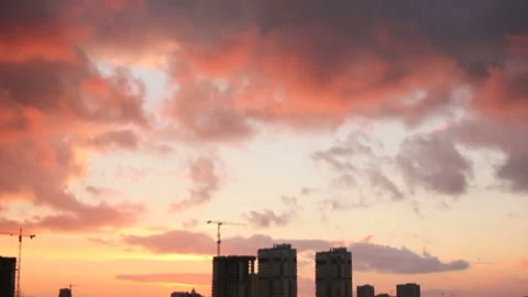 Colored evening clouds over town buildings Stock Footage 125024570