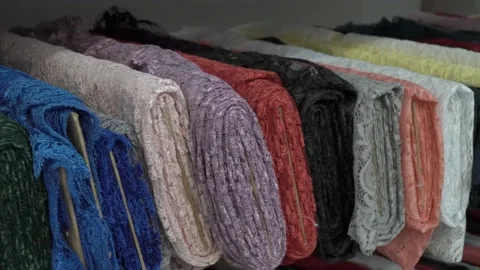 Colored fabrics in rolls on store shelves Video stock 169726464