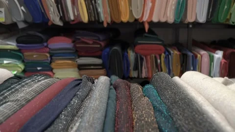 Colored fabrics in rolls on store shelves Stock Footage 169726553