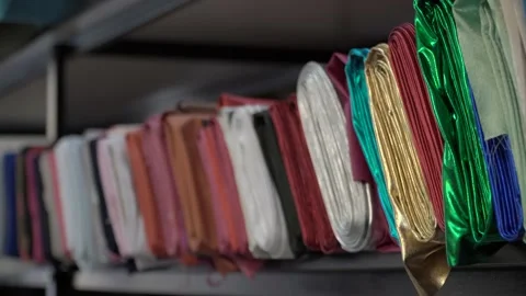 Colored fabrics in rolls on store shelves Video stock 169728212