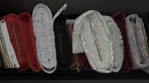 Colored fabrics in rolls on store shelves Stock Footage 169728230