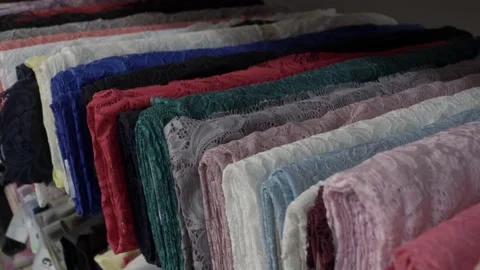 Colored fabrics in rolls on store shelves Video stock 169728462