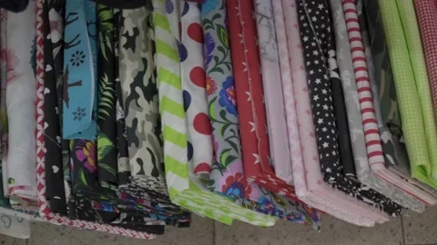 Colored fabrics in rolls on store shelves Stock Footage 169728526