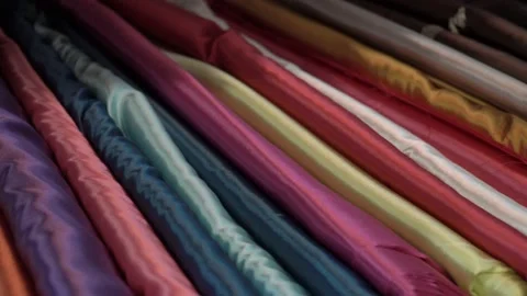 Colored fabrics in rolls on store shelves Stock Footage 169728866