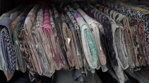 Colored fabrics in rolls on store shelves Stock Footage 169728889