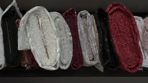 Colored fabrics in rolls on store shelves Stock Footage 169728936