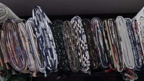 Colored fabrics in rolls on store shelves Stock Footage 169728954