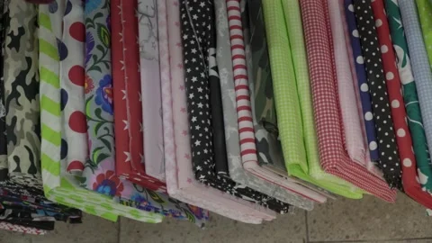 Colored fabrics in rolls on store shelves Stock Footage 169729194
