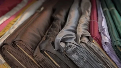 Colored fabrics in rolls on store shelves Stock Footage 169729359