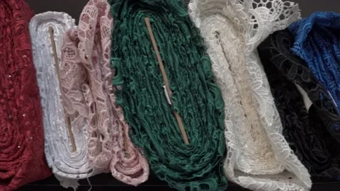 Colored fabrics in rolls on store shelves Stock Footage 169729364