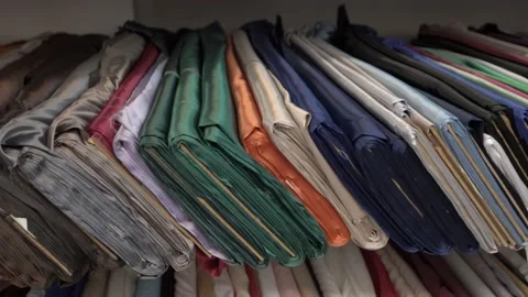 Colored fabrics in rolls on store shelves Stock Footage 169729395