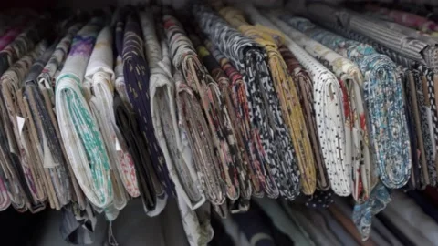 Colored fabrics in rolls on store shelves Stock Footage 169729426
