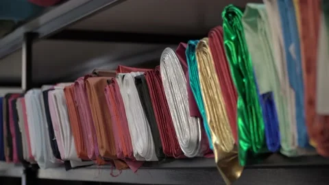 Colored fabrics in rolls on store shelves Stock Footage 169729699