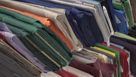 Colored fabrics in rolls on store shelves Stock Footage 169729730