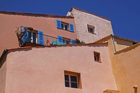 Colored facades on a background of cloudless sky in Antibes, Azure shore, Fra Stock Photos