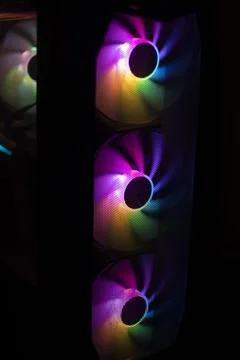 Colored fan in the computer. LED lighting in the system unit. Bright light .. Stock Photos