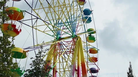 Colored ferris wheel on a cloudy day Stock Footage 65210161