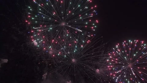 Colored firecracker against the dark night sky during a festive event. Glowing Stock Footage 169534347