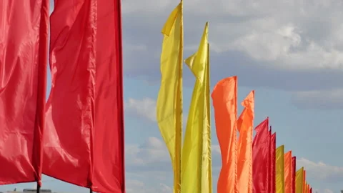 Colored flags against blue sky Stock Footage 98493856