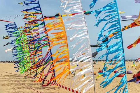 Colored flags against the blue sky with white clouds on holidays 스톡 사진