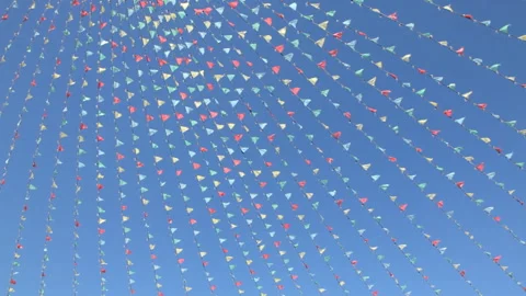 Colored flags swaying in the wind against the blue sky Video stock 91269704