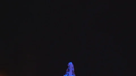 A colored fountain on a black background, slow motion Stock Footage 78635751