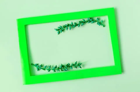 A colored frame decorated with blue branches on a colored background . Stock Photos