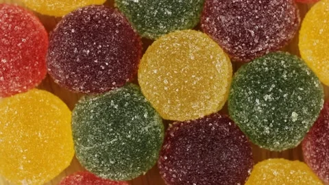 Colored fruit jelly rotates. Sweets marmalade close-up top view. Stockbeeldmateriaal 152407132