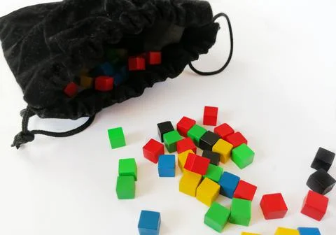 Colored, game cubes next to a black storage bag. Bright cubes for children. C Foto stock