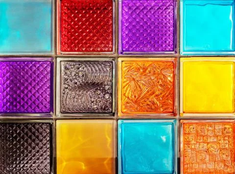 Colored glass blocks with embossed patterns. Multi-colored glass squares. Stock Photos