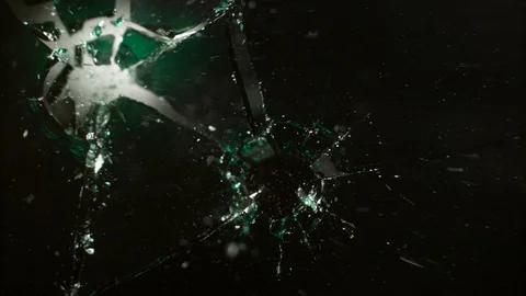 Colored Glass breaking in slow motion on black background Stock Footage 126223707