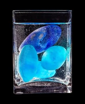 Colored glass in rectangular vase Stock Photos