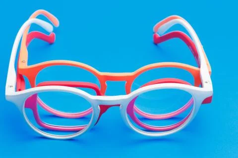 Colored glasses on plain background, modern glasses for fashion. Stock Photos