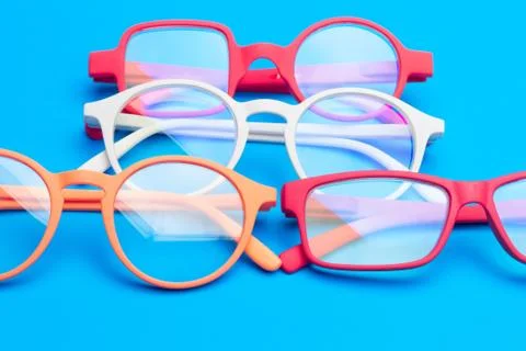 Colored glasses on plain background, modern glasses for fashion. Stock Photos