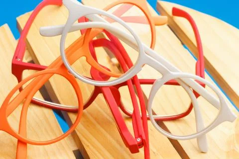 Colored glasses on plain background, modern glasses for fashion. Stock Photos