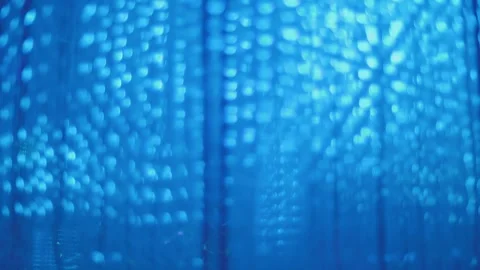 Colored glow of thousands of LEDs in hanging strips with flashes and fading Video stock 323901502