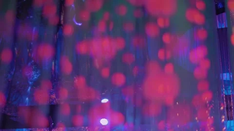 Colored glow of thousands of LEDs in hanging strips with flashes and fading Stock Footage 323918546