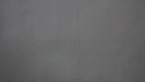 Colored green ray creeps along the gray wall Stock Footage 140016869