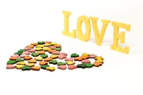 Colored heart shape and love word on white background. Shabby style. Stock Photos