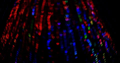 Colored heart-shaped bokeh flash in the dark background Stock Footage 244640718