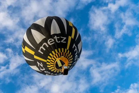 Colored hot air balloon fly over a beautiful cloudy sky Stock Photos