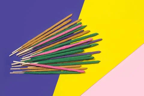 Colored incense sticks on a multicolor background in a top view Foto stock