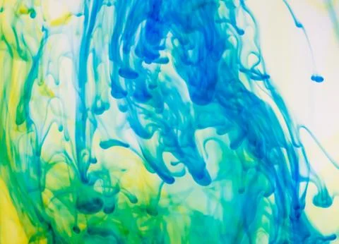 Colored ink cloud grows in water. Stock Photos