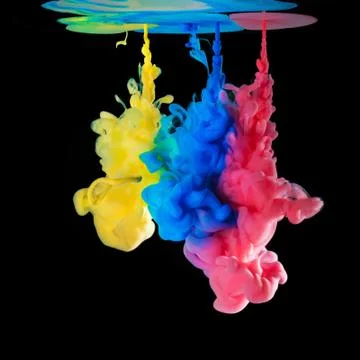 Colored inks in water on black background Stock Photos