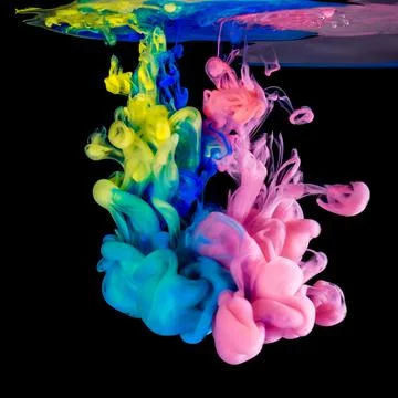 Colored inks in water on black background Foto stock
