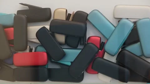 Colored IQOS Electronic Cases Piled Together  Recycling 스톡 동영상 300092181