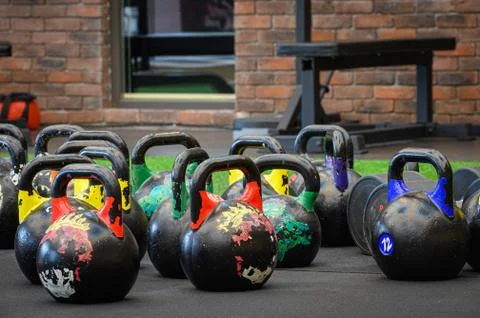 Colored kettle bells in gym Stock Photos