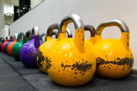 Colored kettlebels on a rubber mat Stock Photos